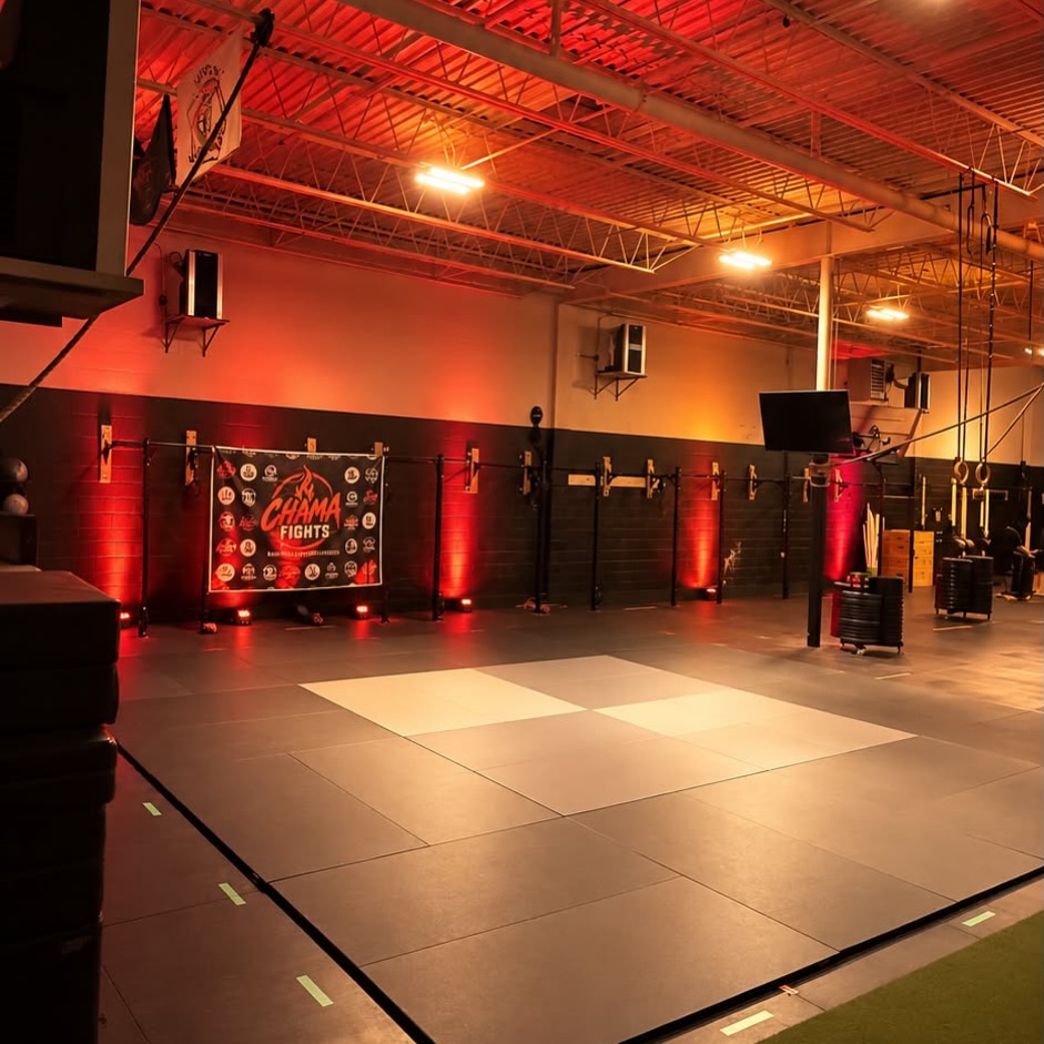 Chama Fights event venue with lit mats and sponsor banner