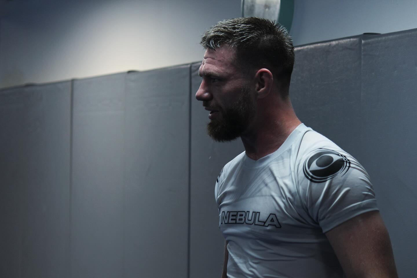 Athlete wearing a white Nebula no-gi top during training